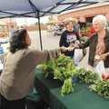 Berthalene Moore, right, and Tammie Shelley, both of Farmington, buy vegetables Saturday from Nena Y...
