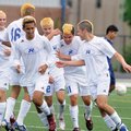 Rogers senior Erik Mora, second from right, celebrates with his teammates after a first-half goal du...