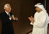 Italian fashion designer Giorgio Armani, left, puts a piece ribbon in his pocket after he cut it with Emaar Properties Chairman Mohammed Al Abbar, after the opening of the Armani Hotel in Burj Khalifa, world's tallest building in Dubai, United Arab Emirates, Tuesday.