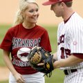 Natalie White of Van Buren receives a baseball from the University of Arkansas' Tom Hauskey after sh...