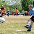 Logan Turner, 7, scores a goal off a corner kick Saturday during a soccer game at Memorial Park in B...