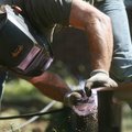 Stuart Fulbright welds together the steel pieces for a raised vegtable bed outside his home near Wil...