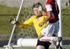 Springdale High’s Santos Martinez takes a shot at the goal while Russellville keeper Kiril Paletskih makes the stop Monday during their semifinal match in the Class 7A State Soccer Tournament in Rogers.