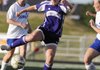 Fayetteville’s Casey O’Brien pushes the ball as Bryant’s Katie Moore, left, and Lauren Reed, right, defend on Monday in Mountie Stadium in Rogers.