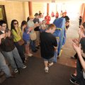 Ryan Neighbors of Skiatook, Okla., center, and Ben Caudle of Tulsa, Okla., both piano movers for Sai...