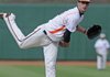 Rogers Heritage’s Hunter Wood pitches against Rogers High on Monday in Arvest Ballpark in Springdale. The War Eagles lost 9-6.