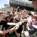Tyler Richardson (left), 10, and others reach items out to be autographed by Naturals outfielder Nic...