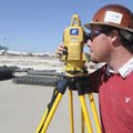 Jesiah Proctor with Lithko of Catoosa, Okla., uses survey equipment Wednesday to set up a base stati...