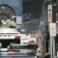 A hostage, right, is released during a bomb threat aboard a bus which cleared much of downtown Ports...