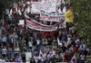 Pro communist protesters march during an anti government rally in Athens on Thursday. Greek lawmakers approved a crucial austerity bill Thursday needed to tap €110 billion ($140 billion) in bailout loans from other eurozone countries and the International Monetary Fund, as massive crowds gathered outside parliament to protest the measures. The bill passed with 172 votes in favor and 121 against. Greeks have been outraged by the government's proposed fiscal measures, and demonstrations turned violent on Wednesday during a nationwide general strike, leaving three people dead after becoming trapped in a burning bank torched by demonstrators. (AP Photo/Dimitri Messinis)