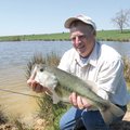 Ronnie Bell admires a 6-pound largemouth bass he caught from one of the ponds on his farm near Hinds...