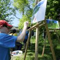 Logen Peterson, 13, left, and Hector Torres, 12, finish their landscape paintings Wednesday during L...