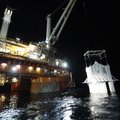 The containment vessel is lowered into the Gulf of Mexico on Thursday at the site of the Deepwater H...