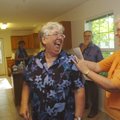  Reeda Rush, left, laughs with friend Nancy Ortman on Thursday evening inside Rush’s new Habitat for...