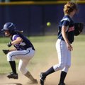  Rogers Heritage second baseman Brooke Franklin, right, watches as the throw from the infield sails ...