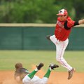  Mansfield senior shortstop Kent Elmore, top, leaps to corral the throw from the plate as Greenland'...