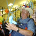 A crazy hat worn by George Lent of Rogers makes shoppers laugh Friday when they visit his balloon-fi...