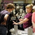 Karen Lockhart, middle, tries on a ring Friday as Marge Brown, right, and Rhonda Manichia, left, own...