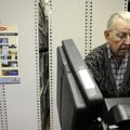  Wallace Dressler of Rogers casts his votes on an electronic voting machine Wednesday while taking a...