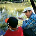 Jeff Courtway gives a few fishing pointers to a child Saturday at the Hooked on Fishing not Drugs an...