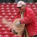 Facilities Supervisor for softball Kevin Jones spreads conditioner over the infield at Bogle Park af...