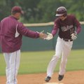 Lincoln’s Cheyenne Vaughn is congratulated at third base by head coach Brad Harris after he hit a gr...