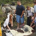 An injured woman is attended to north of Highway 9 after a tornado touched down on Monday in Norman,...