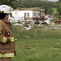 Slaughterville fire chief Paul Long surveys the damage in the mobile home community of Prairie Creek...