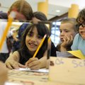 Adriana Dominguez, 8, challenges her brain by attempting to write her name by using her reflection i...