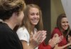 Debbie Hesseltine, left, and Katie Hesseltine applaud Har-Ber high jumper Kirstie Hesseltine, center, before she signs a letter of intent with the University of Arkansas on Tuesday in Springdale.