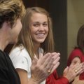 Debbie Hesseltine, left, and Katie Hesseltine applaud Har-Ber high jumper Kirstie Hesseltine, center...
