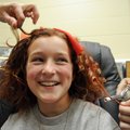 Kendall Yarbrough, 10, has her hair curled and colored by Lesa Owens, left, and classmate Skyler Owe...