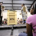 Cyana Current, 9, right, watches actors Jason Suel, left, and Christy Hall portray the roles of a Fr...