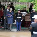 A Marine Corps gunnery sergeant escorts Sharon Easterly Messender back to her vehicle Saturday after...