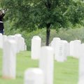 A bugler plays taps Saturday for the funeral of Lance Cpl. Richard Penny at Fayetteville National Ce...