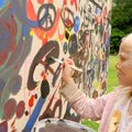 MAKING HER MARK - Kiara Wright, 7, adds her artwork Saturday to a panel during a fundraiser for the ...
