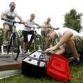  Jesse Adams of Springdale checks on the power conditioner/power inverter while Stan Sasser (from le...