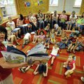 Sue Ann Pekel, director of the Bentonville Public Library’s Children’s Library, reads “My Garden” to...