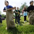 Luis Hernandez, left, and Lim Lee compete Wednesday in a gunny sack race at Cane Hill College. Fourt...