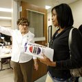 Adrienne Richard of Bentonville is guided Monday to an open station by election official Nancy McClo...