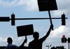 Supporters and politicians wave signs at Broadway traffic as the last day of early voting winds down at the Pulaski County Regional Building at 501 W. Markham Street in Little Rock.