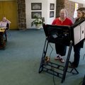 Linda Lee, right, a poll worker helps set the electronic voting machine for Paula Johns to use at th...