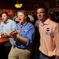 Supporters of Greg Leding, from right, Jody Bland, Will Watson and Caleb Rose react to results as th...