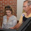 Jenny Miller is assisted Tuesday by election clerk Dan Malek in Precinct 32 at First Presbyterian Ch...