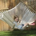  Marley Hudspeth, 7 of Fayetteville, enjoys an after school snack as she relaxes in a backyard hamm...
