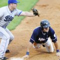 Northwest Arkansas’ Nick Van Stratten safely slides back to first base before Tulsa’s Kiel Roling, l...