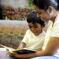 Gowri Venkatesane reads on Wednesday to her son, Aarya, 3, at the Rogers Public Library. Venkatesane...