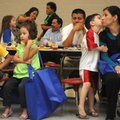 Isabel Thompson, right, gets a kiss Thursday from son David Thompson, 5, during the English as a Sec...