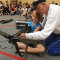 CROSSBOW CLASS - Freddie Jones, a longtime Rogers educator who retired last year, shows Shelby Seal,...
