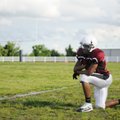 BULLDOG BREATHER - Springdale High School’s K.D. Jones takes a knee Thursday while watching the soph...